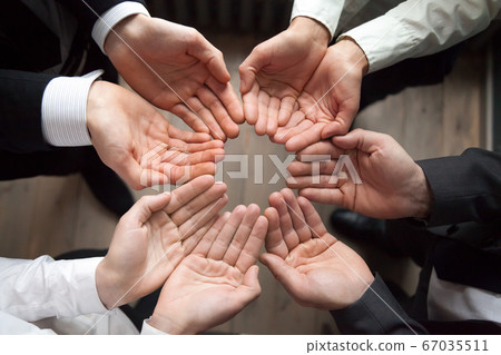 Business team join hands in circle palms up, growth concept Business team join hands in circle palms up, growth concept 67035511