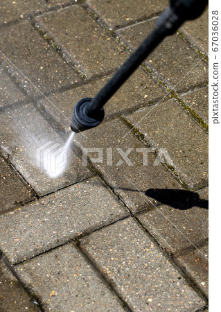 high-pressure washer clean the dirt of garden line in country house 67036028