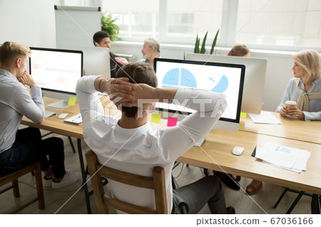 Employee analyzing statistics report sharing office desk with di 67036166