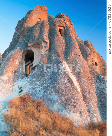 Cave Dwellings in an Arid Landscape in Cappadocia Cave Dwellings in an Arid Landscape in Cappadocia 67036629