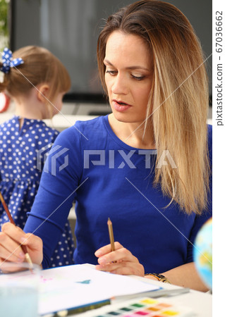 Blond smiling little girl hold in arm brush Blond smiling little girl hold in arm brush 67036662