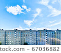 Mobile photo. Residential high-rise building and blue sky. 67036882