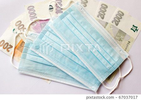 Masks are placed on banknotes of the czech crown Masks are placed on banknotes of the czech crown 67037017