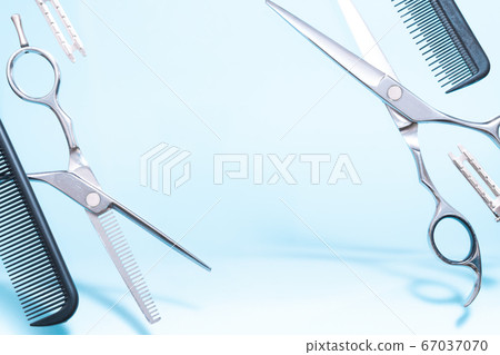 Flying hairdresser tools comb, scissors under trendy color background with copy space and soft light 67037070