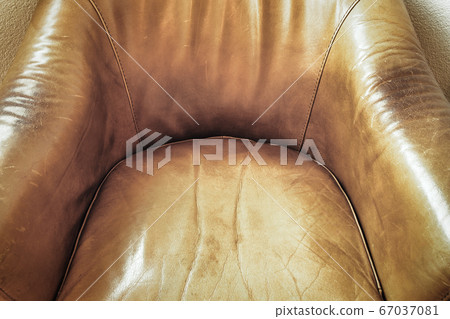 Detail of an old brown leather chair, Leather chair close-up. Leather texture material background Detail of an old brown leather chair, Leather chair close-up. Leather texture material background 67037081