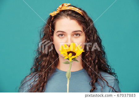 Beautiful woman with yellow flower Beautiful woman with yellow flower 67037883