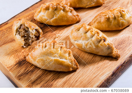 Hot pasties from butter enriched puff pastry Hot pasties from butter enriched puff pastry 67038089