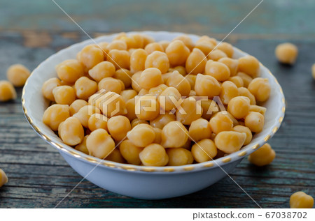 A Bowl of cooked chickpeas on the wooden table -, 67038702