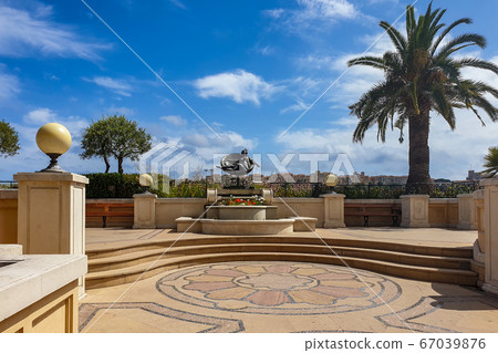 Small square and a statue in Monaco 67039876