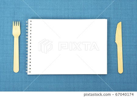 Sketchbook and fork and knife on the placemat Sketchbook and fork and knife on the placemat 67040174