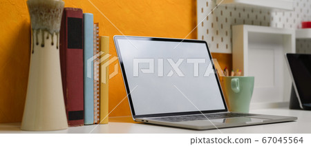 Mock-up laptop on creative office desk with Mock-up laptop on creative office desk with 67045564
