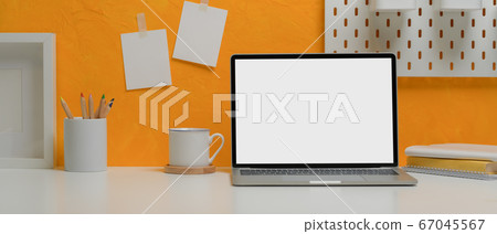 Blank screen laptop on creative home office desk 67045567