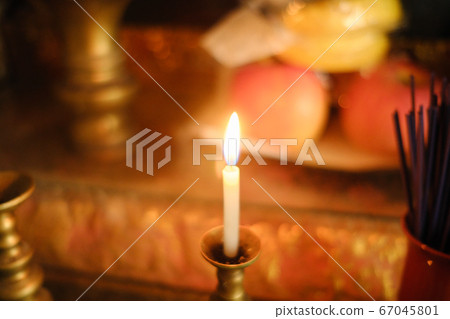 Candle fire on the altar 67045801