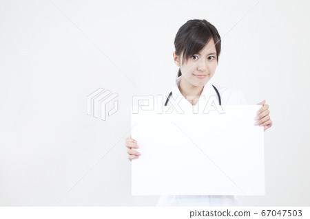 Female nurse with message board Female nurse with message board 67047503