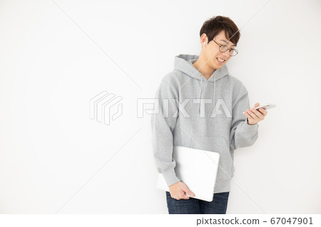 Man listening to audio with earphones 67047901