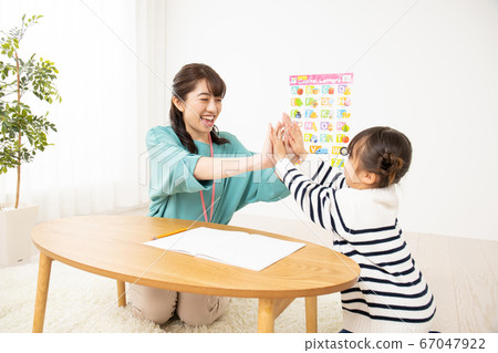 High-five teacher and infant High-five teacher and infant 67047922