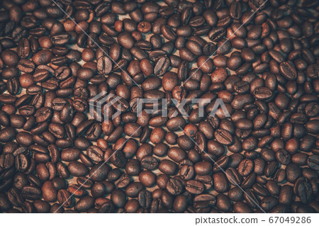 Coffee beans placed on old wooden boards with free 67049286