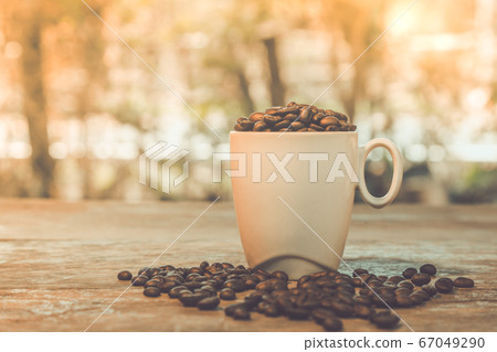 The coffee beans in the cups on the old wooden The coffee beans in the cups on the old wooden 67049290