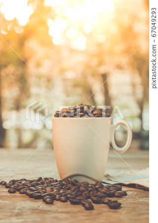 The coffee beans in the cups on the old wooden The coffee beans in the cups on the old wooden 67049293