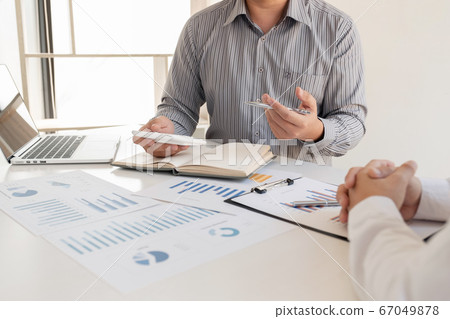 Two business leaders discussing the charts and graphs showing the results, Planning to start a new strategy for big success 67049878