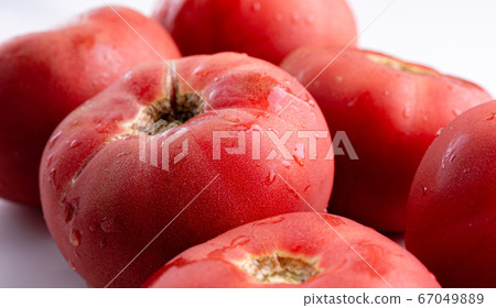 Rose tomatoes close up on white table. Autumn or summer harvest. fresh organic food from garden 67049889
