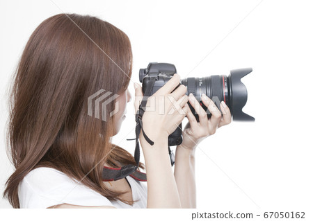 A woman holding a camera A woman holding a camera 67050162