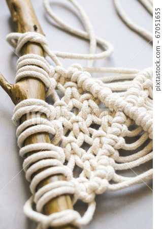 Handmade knitting macrame. Boho lifestyle. Hobby hobby concept. Selective focus vertical frame 67051655