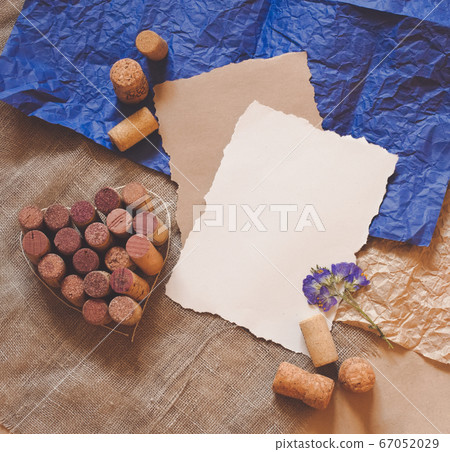 Red wine cork heart, white and craft paper sheets. Free copy space for text. Red wine cork heart, white and craft paper sheets. Free copy space for text. 67052029