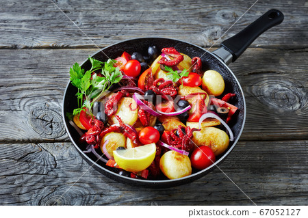 Baby octopus with young potatoes on a frying pan Baby octopus with young potatoes on a frying pan 67052127