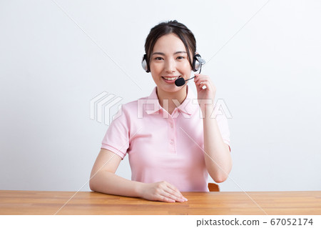 A woman wearing a headset and talking from the camera's perspective A woman wearing a headset and talking from the camera's perspective 67052174