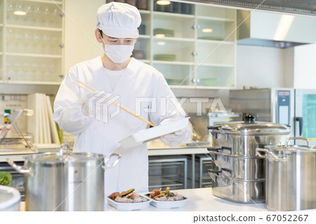 Male cook serving lunch with home meal delivery takeout 67052267