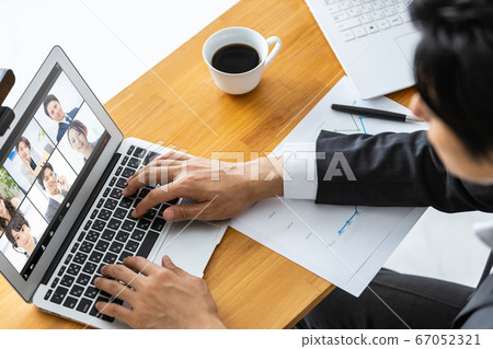Businessman attending an online meeting Businessman attending an online meeting 67052321