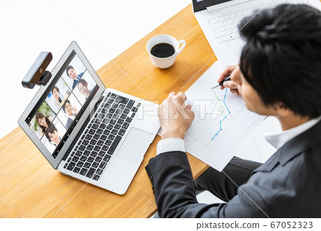 Businessman attending an online meeting Businessman attending an online meeting 67052323