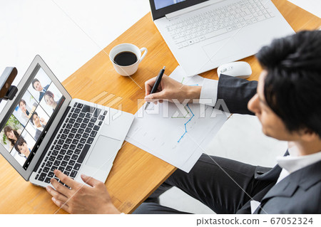 Businessman attending an online meeting 67052324
