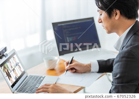 Businessman attending an online meeting 67052326