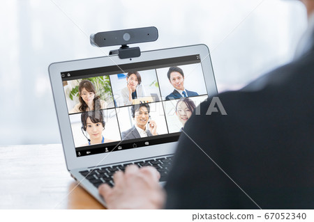 Businessman attending an online meeting 67052340