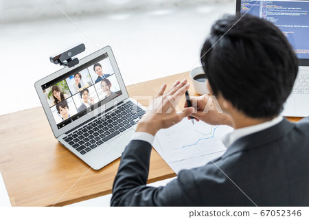 Businessman attending an online meeting 67052346