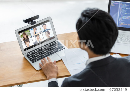 Businessman attending an online meeting 67052349