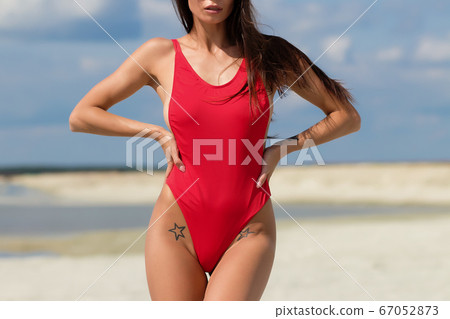 Beautiful woman in swimsuit on beach Beautiful woman in swimsuit on beach 67052873
