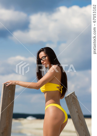 Beautiful woman in swimsuit on beach Beautiful woman in swimsuit on beach 67053102
