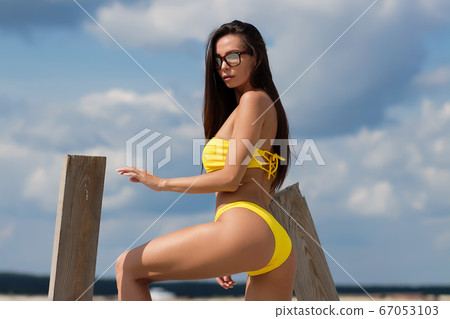 Beautiful woman in swimsuit on beach Beautiful woman in swimsuit on beach 67053103