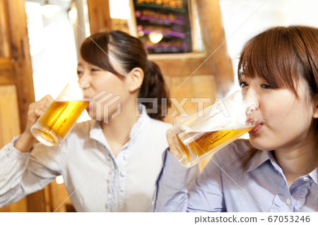 Woman drinking draft beer Woman drinking draft beer 67053246