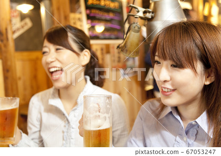 Woman drinking draft beer 67053247