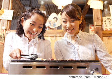 Woman grilling meat Woman grilling meat 67053258