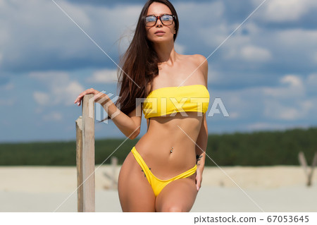 Beautiful woman in swimsuit on beach Beautiful woman in swimsuit on beach 67053645