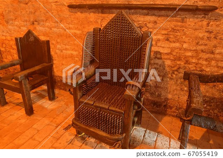 A torture device - the Iron Chair. The victim was seated on several strips or plates of brass and placed over an open flame and slowly roasted alive A torture device - the Iron Chair. The victim was seated on several strips or plates of brass and placed over an open flame and slowly roasted alive 67055419