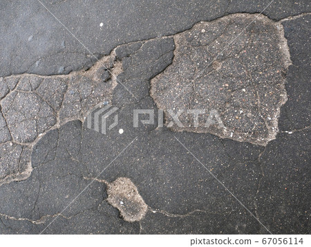 Cracked asphalt surface texture. Cracked asphalt surface texture. 67056114