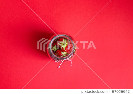 Flatlay composition on a glass jar on a red 67056642