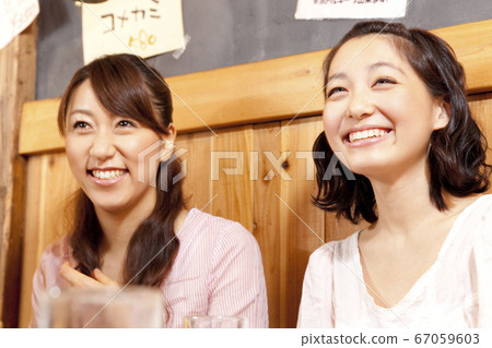 A woman talking in a pub 67059603