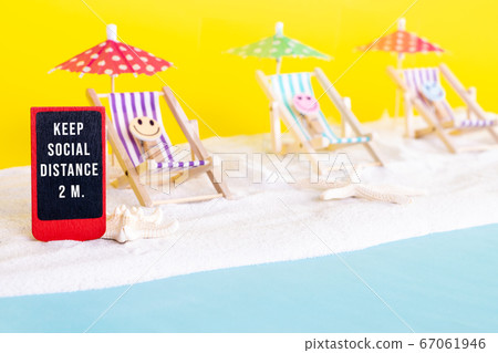 COVID 19 protection on beach vacation. Deckchairs separated by glass partitions on sand background. COVID 19 protection on beach vacation. Deckchairs separated by glass partitions on sand background. 67061946